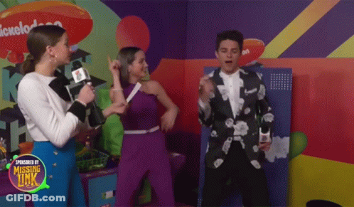 A Group Of People Standing In Front Of A Nickelodeon Sign GIF