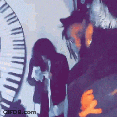 A Group Of People Standing In Front Of A Piano Keyboard . GIF