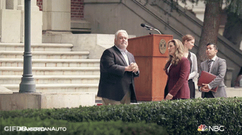People Standing In Front Of NBC Podium GIF