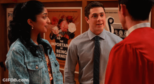 A Group Of People Standing In Front Of A Poster That Says The Important Of Being Earnest GIF