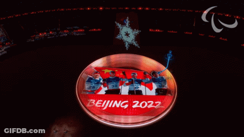 Group Standing In Front Of Beijing 2022 Screen GIF