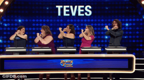 A Group Of People Standing In Front Of A Screen That Says Teves On It GIF