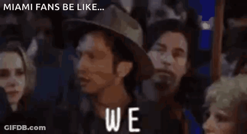 A Group Of People Standing In Front Of A Sign That Says " Again " GIF
