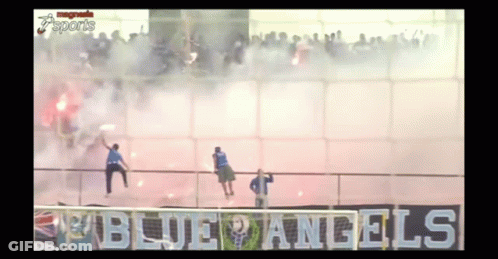 A Group Of People Standing In Front Of A Sign That Says " Blue Angels " GIF