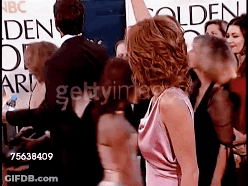 A Group Of People Standing In Front Of A Sign That Says Golden Globe Awards GIF