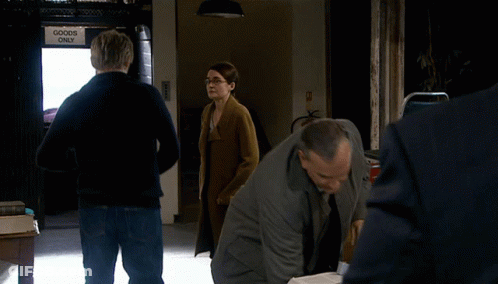 A Group Of People Standing In Front Of A Sign That Says Goods Only GIF