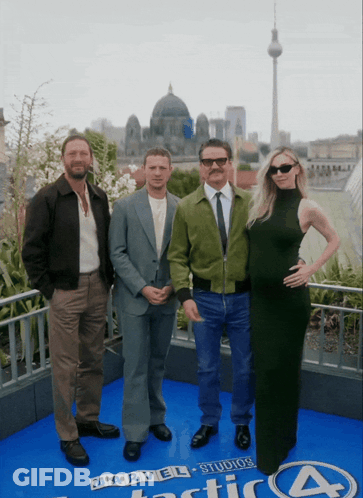 A Group Of People Standing In Front Of A Sign That Says Marvel Studios Fantastic Four GIF