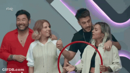 A Group Of People Standing In Front Of A Sign That Says " Rtve " GIF