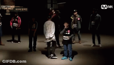 A Group Of People Standing In Front Of A Sign That Says ' Show Me The Money ' GIF