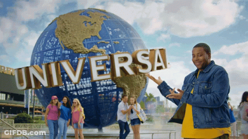 A Group Of People Standing In Front Of A Universal Sign GIF