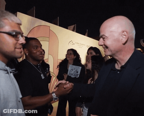 A Group Of People Standing In Front Of A Wall That Says Global Changing GIF