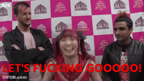 A Group Of People Standing In Front Of A Wall That Says Let 'S Fucking Gooooo ! GIF