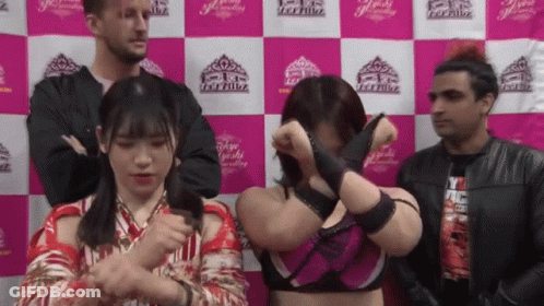 A Group Of People Standing In Front Of A Wall That Says Tokyo GIF