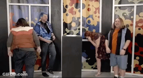 A Group Of People Standing In Front Of A Window With A Woman Laughing GIF