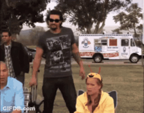A Group Of People Standing In Front Of An Ice Cream Truck That Says Ice Cream GIF
