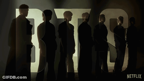 A Group Of People Standing In Front Of The Word Bts On Netflix GIF