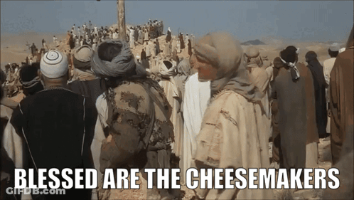 A Group Of People Standing In The Desert With The Words Blessed Are The Cheesemakers GIF