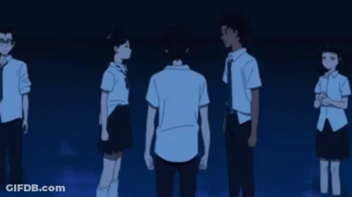 A Group Of People Standing Next To Each Other In A Dark Room With A Man Hanging From The Ceiling . GIF