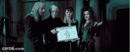 A Group Of People Standing Next To Each Other In A Room Holding A Sign That Says `` Harry Potter '' . GIF