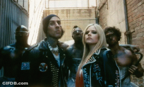 A Group Of People Standing Next To Each Other In An Alleyway GIF