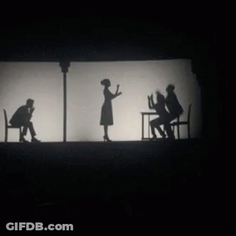 A Group Of People Standing Next To Each Other On A Stage GIF