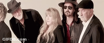 A Group Of People Standing Next To Each Other Wearing Hats . GIF