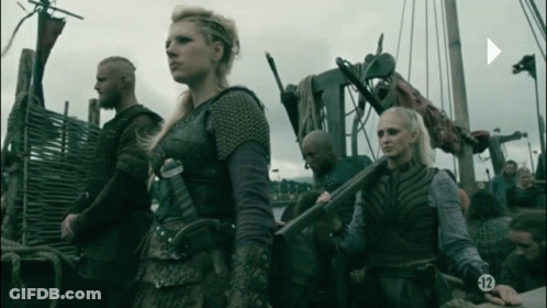 A Group Of People Standing Next To Each Other With The Number 12 On Their Sleeves GIF