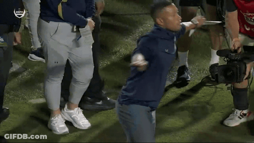 A Group Of People Standing On A Field With Espn On The Bottom GIF