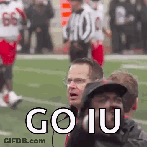 A Group Of People Standing On A Football Field With The Words Go Iu Written On The Bottom GIF