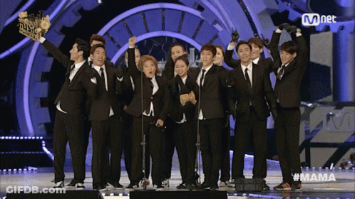 A Group Of People Standing On A Stage With The Word Mama On The Bottom GIF