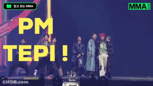 A Group Of People Standing On A Stage With The Words Pm Tepi Written In Yellow Letters GIF