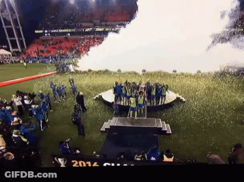 A Group Of People Standing On A Stage With The Year 2014 On The Bottom Left GIF