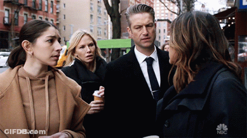 A Group Of People Standing On A Street With The Nbc Logo On The Bottom Left GIF