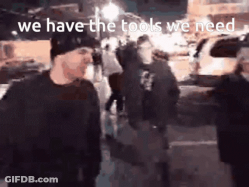 A Group Of People Standing On A Street With The Words We Have The Tools We Need GIF