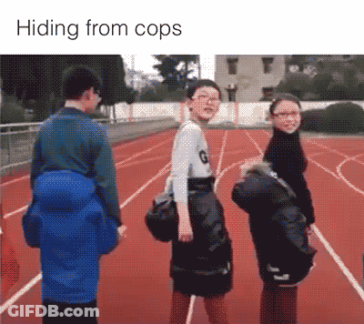 A Group Of People Standing On A Track With The Words Hiding From Cops Below Them GIF