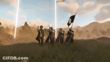 A Group Of People Standing On Top Of A Grass Covered Field Holding Flags . GIF