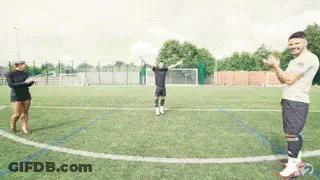 A Group Of People Standing On Top Of A Soccer Field Applauding . GIF
