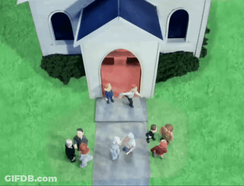 A Group Of People Standing Outside Of A White Church GIF