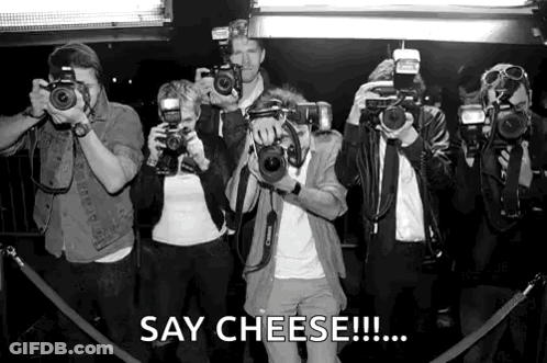 A Group Of People Taking Pictures With Cameras And The Caption Say Cheese GIF