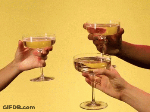 A Group Of People Toasting With Champagne Glasses GIF