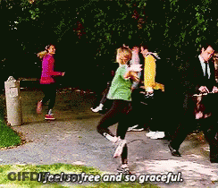 A Group Of People Walking Down A Sidewalk With The Words " I Feel So Free And So Graceful " GIF