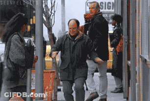 A Group Of People Walking Down A Street With A Sign That Says Sign GIF