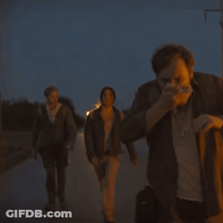 A Group Of People Walking Down A Street With One Wearing A T-Shirt That Says ' I Love You ' On It GIF