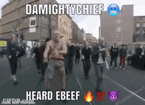 A Group Of People Walking Down A Street With The Words Damightychief Heard Ebeef On The Bottom GIF