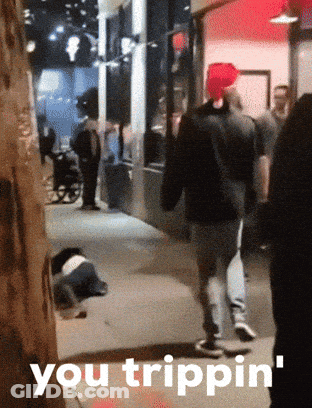 A Group Of People Walking Down A Street With The Words You Trippin ' On The Bottom Right GIF