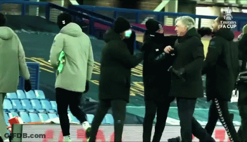 A Group Of People Walking On A Soccer Field With The Emirates Fa Cup Written On The Bottom GIF