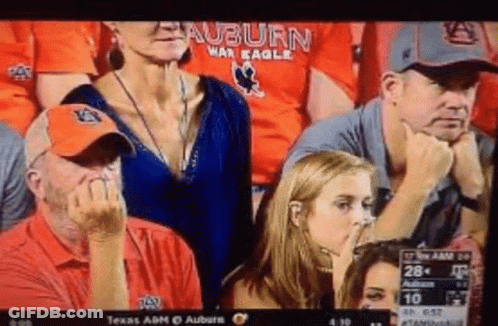 A Group Of People Watching A Football Game With The Auburn War Eagles On Their Shirts GIF