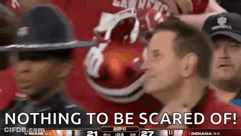 A Group Of People Watching A Football Game With The Words Nothing To Be Scared Of On The Screen GIF