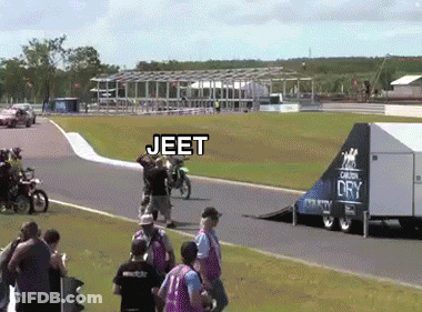 A Group Of People Watching A Motorcycle Race With Jeet Written On The Bottom Right GIF