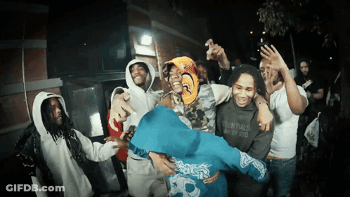 A Group Of People Wearing Essentials Sweatshirts Are Dancing GIF